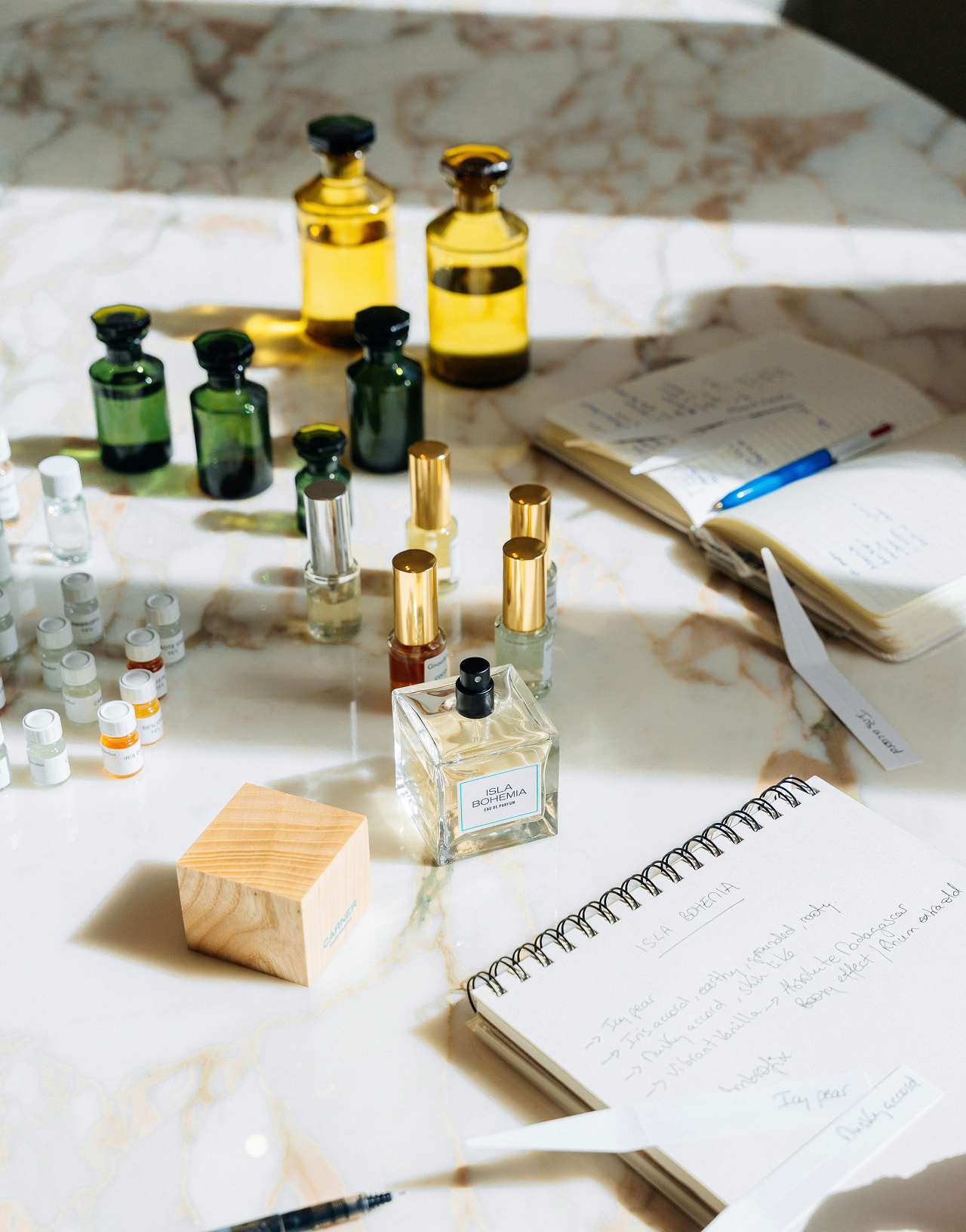 Carner Barcelona olfactory workshop table with perfume bottles and notebook